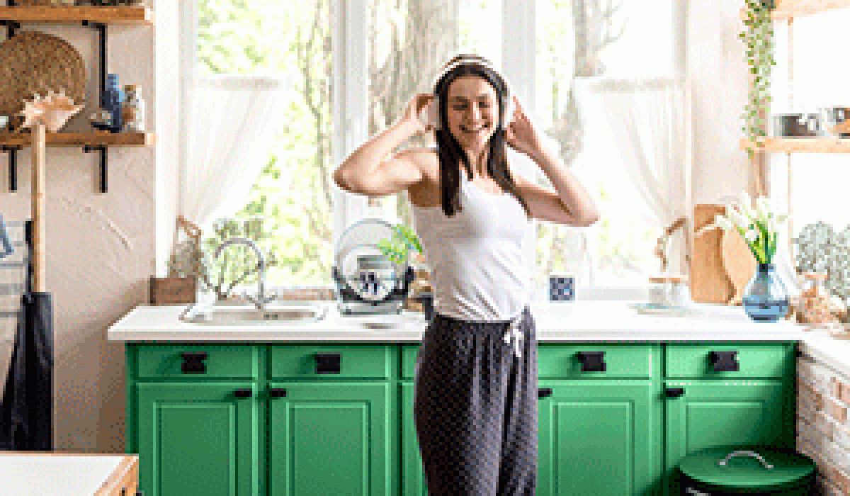 woman-listening-music-green-kitchen